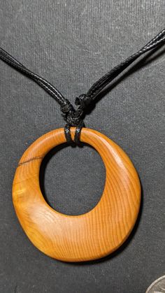 Unique necklace made from Huon Pine. Huon Pine only grows in the small island of Tasmania, Australia. Huon Pine grows slowly with trees thousands of years old. Artisan Necklace In Natural Wood As A Gift, Artisan Necklaces In Natural Wood As Gift, Handmade Natural Wood Pendant Jewelry, Artisan Natural Wood Necklace As A Gift, Artisan Natural Wood Necklaces For Gift, Unique Adjustable Necklace With Natural Variations, Round Natural Color Necklace As Gift, Round Necklace In Natural Color For Gift, Natural Color Necklace For Gift