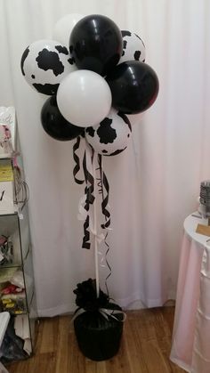 some black and white balloons in a room