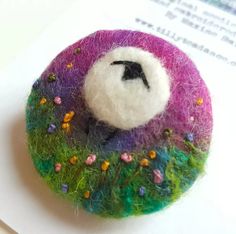 there is a small felt brooch on the table