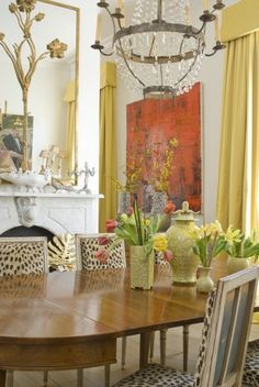 a dining room table with chairs and a chandelier