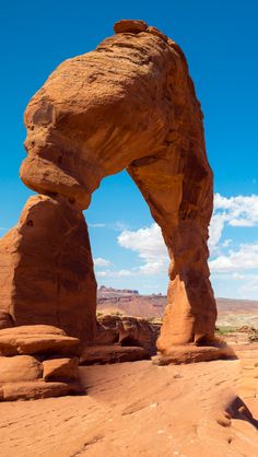 an arch shaped rock formation in the desert