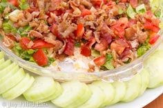 a salad on a plate with sliced cucumbers