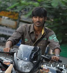 a man riding on the back of a motorcycle next to other motorbike's