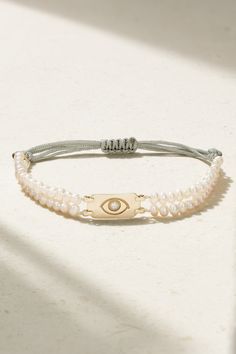 Diane Kordas' 'Double Strand' bracelet is strung with white pearls, which are believed to bring prosperity and peace. The 18-karat gold charm is engraved with an evil eye and set with a single diamond in the center. The cord is adjustable, so you can customize the fit. Luxury Adjustable Pearl Chain Bracelet, Adjustable White Gold Pearl Bracelet, Adjustable White Gold Pearl Bracelet With Pearl Charm, Luxury Adjustable Pearl White Jewelry, Elegant White Evil Eye Bracelet, Adjustable White Gold Bracelet With Pearl Charm, Luxury Pearl Charm Bracelets As Gift, Luxury Pearl Charm Bracelets For Gifts, Luxury Pearl Charm Bracelet As Gift