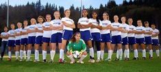 a group of women soccer players posing for a team photo in front of the camera