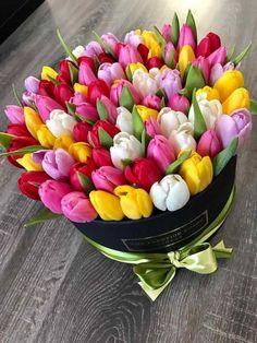 a bouquet of colorful tulips in a black box