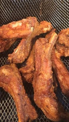 some chicken wings are cooking on a grill