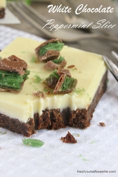 white chocolate peppermint slice on a napkin with a fork and spoon in the background