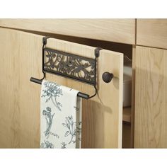 a towel rack is hanging on the side of a cabinet