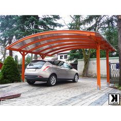 a car is parked under an orange carport