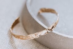 Hammered gold bracelet, Bold wide gold bangle, 18k gold plated cuff bracelet, layering bracelet, textured bangle gold, slip on bracelet Welcome to our store! We're so thrilled to have you here!  This modern gold cuff bracelet is bold and simple, perfect statement jewelry for everyday outfit.  ♥ J E W E L R Y ∙ D E T A I L  - Material: high quality 18k gold layered over brass - Bracelet Length : approx. 7.5 in - Chain width:  6 mm - Hypoallergenic (lead, cadmium and nickel free) ----THIS LISTING Gold Handmade Minimalist Cuff Bracelet, Dainty Hammered Bangle Bracelet, Dainty Tarnish-resistant Bangle Cuff Bracelet, Elegant Hammered Brass Bangle, Minimalist Handmade Gold Bangle, Textured Gold-plated Jewelry, Gold Textured Jewelry For Gifts, Textured Gold Jewelry For Gifts, Textured Gold Jewelry Gift