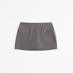 Elevate your wardrobe with the Abercrombie & Fitch Women's Mid Rise Zip Mini Skort, a perfect blend of style and practicality. This chic dark gray skort combines the elegance of a skirt with the comfort of shorts, making it an ideal choice for both casual outings and stylish events.

- Size: XL
- Color: Dark Gray
- Material: Body: Polyester, Lining: Polyester
- Gender: Female
- Features: Mid-rise, front pockets with zipper closure, elasticated waistband for a secure fit

Crafted with a soft poly Workwear Short Skort With Pockets, Casual Mini Skort With Zipper Closure, Workwear Mini Skirt With Zip Fly, Casual Mini Skirt With Zipper For Work, Fitted Short Length Skort With Zipper Closure, Mini Skirt With Pockets And Short Inseam, Casual Mini Length Bottoms With Zipper, Casual Mini Bottoms With Zipper Closure, Spring Skort With Zipper Closure