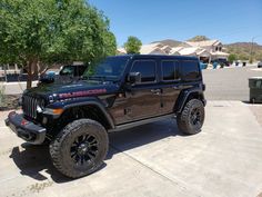 a black jeep parked in front of a house