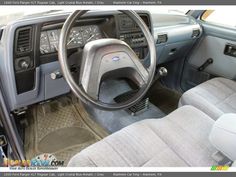 the interior of a car with its dashboard and steering wheel in front of the driver's seat