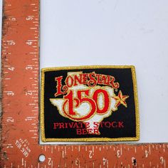 a ruler with a patch on it that says, loneser's 50 private stock bbbe