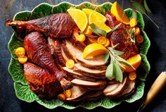 a platter filled with sliced meat and fruit