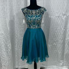 Fit To Flair Teal Dress With A Low Back And Top Full Of Rhinstones In Good Condition A Measurements Chest 33inin Waist 27in Skirts Length 21in Dress Low Back, Sherri Hill Dresses, Teal Dress, Sherri Hill, Low Back, Skirt Length, Blue And Silver, Size 4, Mini Dress