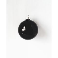 a black ornament hanging on a white wall