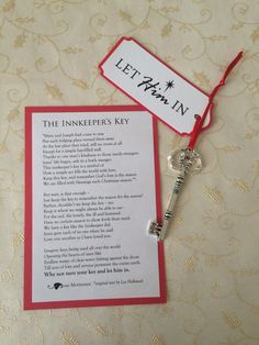 a key with a card attached to it sitting next to a piece of paper that says let him in