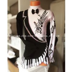 a female mannequin dressed in black and white with musical notes on it's shirt