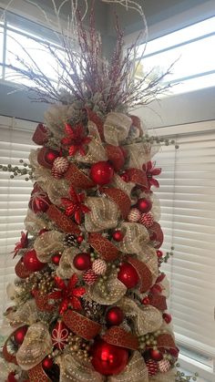 a christmas tree decorated with red and gold ornaments