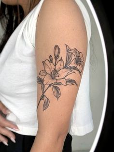 a woman with a flower tattoo on her arm