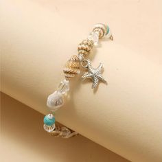 Product Overview Embrace the spirit of summer and enhance your beach attire with our Charming Starfish and Green Stone Beaded Anklet. Perfect for women who love to express their style effortlessly, this anklet combines elegance and playful charm in one beautiful accessory. Whether you're lounging by the sea or dancing at a beach party, this anklet adds a touch of glamour to any outfit. Key Features Material: High-quality zinc alloy that's both durable and lightweight. Design: Adorned with a capt Starfish-shaped Beaded Beach Jewelry, Bohemian White Charm Bracelet For The Beach, Bohemian White Charm Bracelet For Beach, White Bohemian Charm Bracelet For The Beach, Beach Jewelry With Adjustable Star Charm, Beach Adjustable Jewelry With Star Charm, Adjustable Beach Jewelry With Star Charm, Summer Strand Beaded Bracelets With Starfish Charm, Starfish-shaped Beaded Jewelry For The Beach