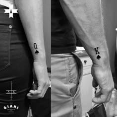 two people with tattoos on their arms and one is holding the other's hand