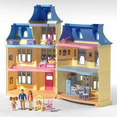 a doll house with furniture and accessories in front of it