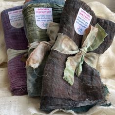 three rolls of fabric with tags on them