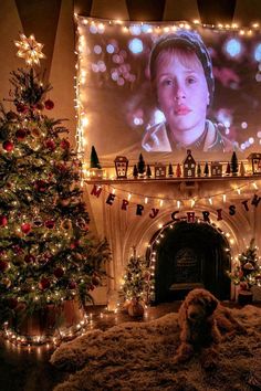 a living room decorated for christmas with lights and a large television screen above the fireplace