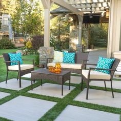 an outdoor patio with furniture and grass on the ground