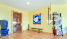 a room with yellow walls and tiled floors