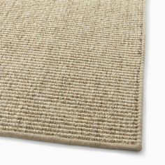 a close up view of a beige rug