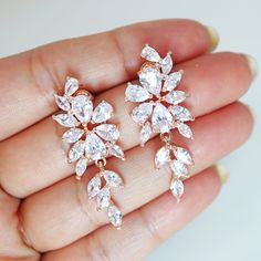 These Beautiful Romantic Swarovski Crystal BRIDAL Flower Leaves Earrings are made of very fine quality of Swarovski Crystals available in Silver, Gold and Rose gold finish for your special day! Even we have hard time taking pictures because of their shine 😄 so we want to shine our brides on their special days. The material used in these earrings are free from Lead, Nickel, Cadmium so it will not give you any skin irritation and environment friendly too.. Cubic Zirconia Dangle Flower Earrings For Wedding, Sparkling Stones Drop Earrings For Wedding, Sparkling Drop Flower Earrings For Wedding, Sparkling Flower Drop Earrings For Wedding, Wedding Crystal Flower Earrings, Wedding Flower Drop Earrings With Sparkling Stones, Cubic Zirconia Flower Earrings For Wedding, Wedding Flower Earrings With Sparkling Cubic Zirconia, Wedding Flower Earrings With Cubic Zirconia In Prong Setting