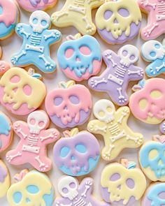 decorated sugar cookies in pastel colors with skulls and crossbones on white background