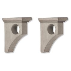 two gray wooden brackets with holes in the middle and one on each side, both facing different directions