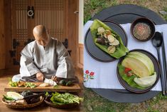 a man sitting at a table with plates of food and chopsticks in front of him