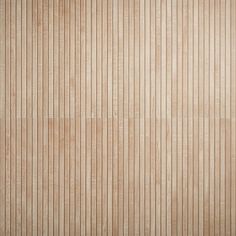 a wooden wall with vertical lines painted on the wood paneling in light brown tones