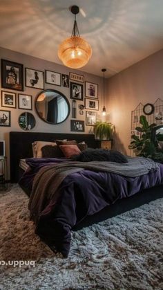 a bedroom with pictures on the wall and a large bed in front of a mirror