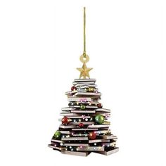 a christmas tree made out of books with an ornament hanging from the top