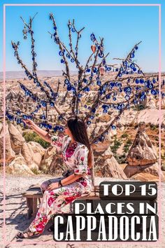 a woman sitting on a bench in front of a tree with the words top 15 places in cappadocia