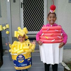 two children dressed in costumes standing on the steps with doughnuts and marshmallows