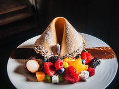 a white plate topped with fruit and pastry