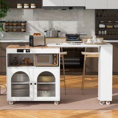 a kitchen with a microwave, oven and counter top in it's center island