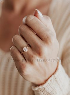 a woman wearing a gold ring with a baguette cut diamond on her finger