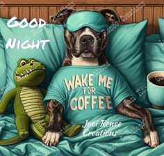 a dog is laying in bed next to a coffee mug and a stuffed alligator that says good night wake me for coffee