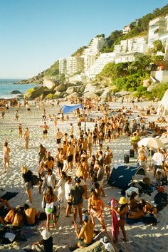 many people are on the beach and in the water