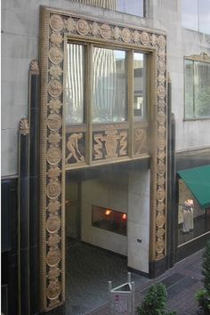 an art deco fireplace in the middle of a building with its reflection on it's glass door