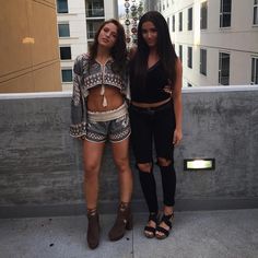 two beautiful young women standing next to each other